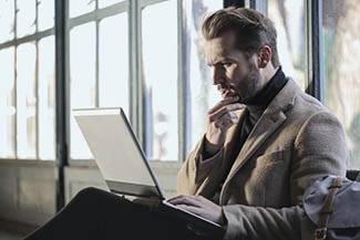 Man staring into his laptop in Olathe, Kansas
