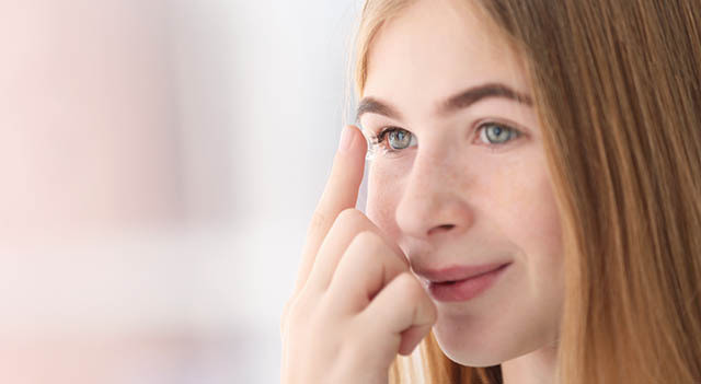 Teenage Putting in Contact Lenses